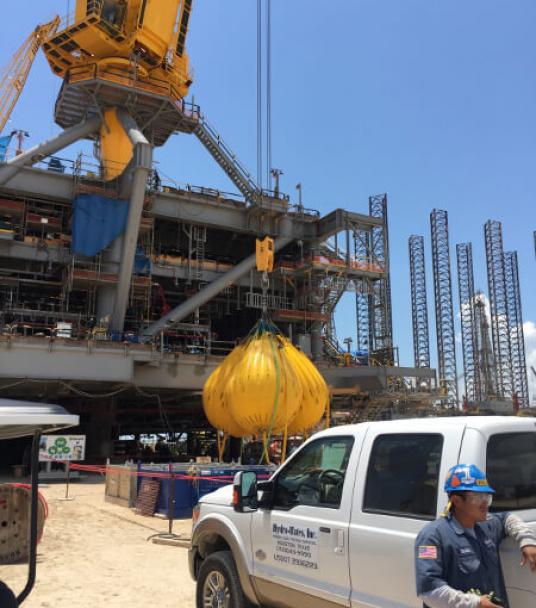 Proof load testing offshore platform crane to 100 tons in construction yard.