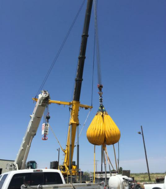 Proof load testing mobile crane with combination of water test weights and steel counter weights.